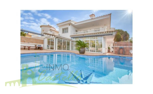 Piscina con terrazas y fachada casa
